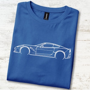 May include: A royal blue short-sleeved t-shirt featuring a white line art graphic of a sports car in profile. The shirt has a crew neckline and a black Gildan brand label visible at the inner collar, showcasing a clean and simple design.