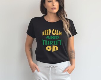 Puede incluir: Camiseta negra con el texto "Keep Calm and Thrift On" en letras verdes y doradas.