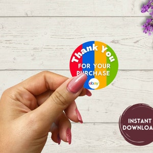 Puede incluir: Pegatina redonda con fondo multicolor. La pegatina dice "Gracias por su compra" con la palabra "ebay" en la esquina inferior derecha.