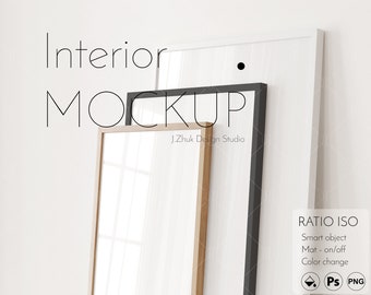 May include: A mockup of three picture frames, one white, one black, and one wood, against a white wall. The frames are stacked on top of each other, with the white frame on top. The text "Interior Mockup" is written in black text at the top of the image. The text "J.Zhuk Design Studio" is written in black text below the frames. The text "RATIO ISO" is written in black text at the bottom right of the image. The text "Smart object" is written in black text below "RATIO ISO". The text "Mat - on/off" is written in black text below "Smart object". The text "Color change" is written in black text below "Mat - on/off". The text "PS PNG" is written in black text below "Color change".