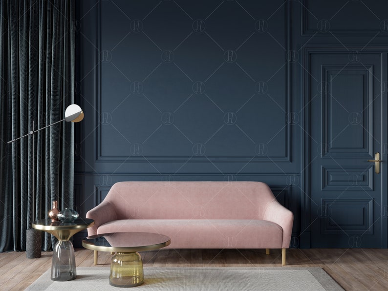 May include: A pink velvet sofa with gold legs sits in a room with dark blue walls and a dark blue door. There are two gold and glass coffee tables in front of the sofa.