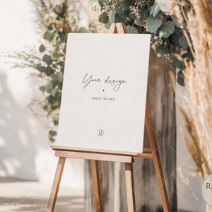 Op de afbeelding: Een wit bord met de tekst "Your design 18x24 inches" op een ezel voor een bloemstuk.