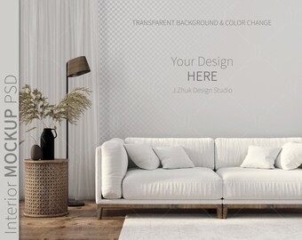 May include: A white sofa with two pillows sits in front of a white wall with a transparent background. The sofa is in a living room setting with a wooden floor and a side table with a vase of dried flowers and a floor lamp.