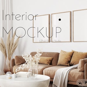 May include: A living room interior mockup with a brown leather sofa, a white throw blanket, and three framed pictures on the wall. The text "Interior Mockup" is written in black on the wall.