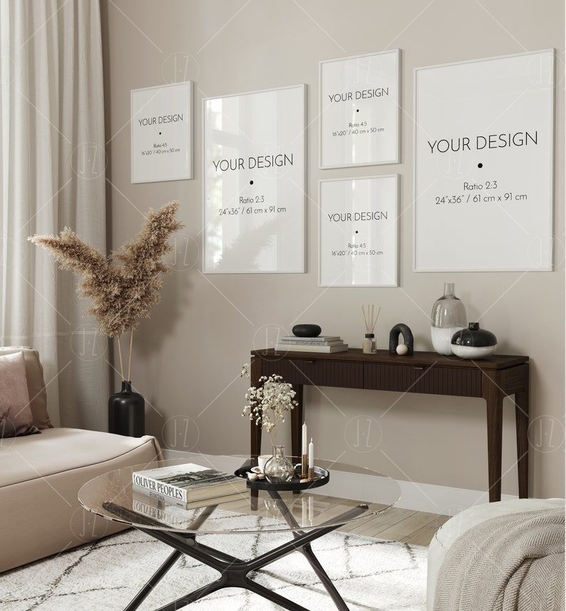 May include: A living room interior with a beige sofa, a glass coffee table, a console table with a vase and candles, and four white framed prints with the text "Your Design" and different size ratios. The prints are hung on a beige wall.