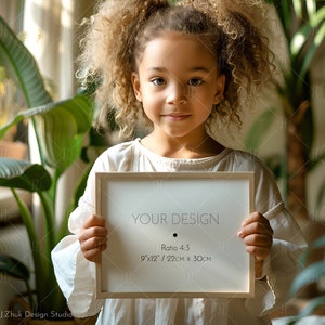 May include: A young person holding a white framed picture with the text "YOUR DESIGN" and the dimensions "9"x12"/ 22cm x 30cm" and "Ratio 4:3".