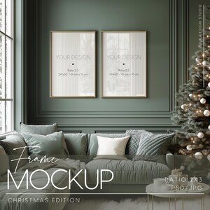May include: Two gold picture frames with white mounts, each displaying the text "YOUR DESIGN" with the dimensions "24"x36"/61 cm x 91 cm" and "Ratio 2:3". The frames are hanging on a dark green wall in a room with a green sofa, white throw, and a Christmas tree with white baubles.