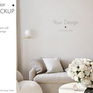 May include: A mockup of a living room interior with a white sofa, a white armchair, a round coffee table, a bouquet of white flowers, and a floor lamp with a white globe. The wall is a light gray with a subtle checkered pattern. The text "Your Design" and "Zhuk Design Shop" is visible on the wall.