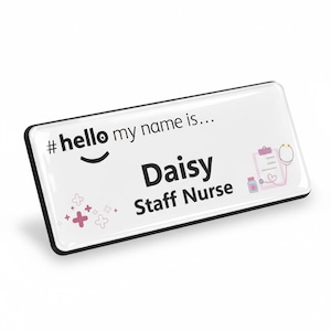 May include: A white rectangular name badge with a black border. The badge features the text "#hello my name is..." and "Daisy Staff Nurse" in black. Pink medical icons and decorative elements are also included.