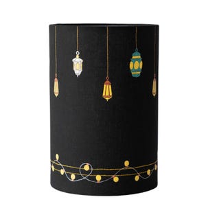 May include: Black lampshade with a string of lights and hanging lanterns in various colors and patterns.