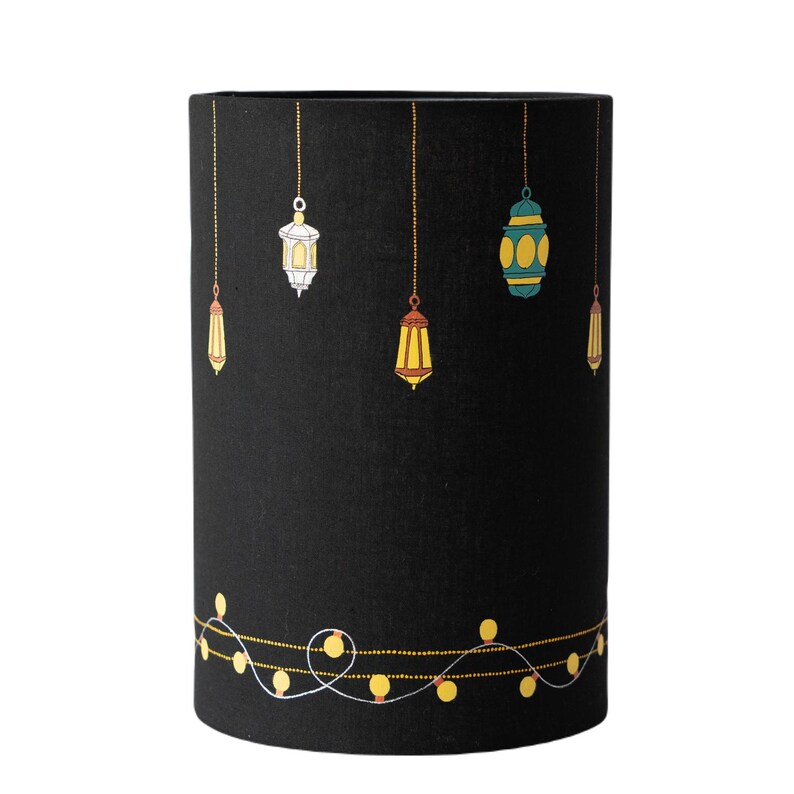 May include: Black lampshade with a string of lights and hanging lanterns in various colors and patterns.