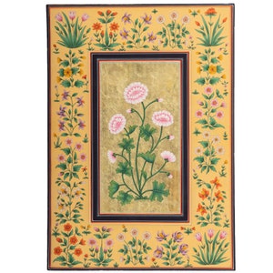 May include: A traditional Indian miniature painting on paper with a gold background. The painting features a central motif of pink flowers with green leaves and stems. The border of the painting is decorated with a variety of smaller flowers in shades of pink, yellow, orange, and green.