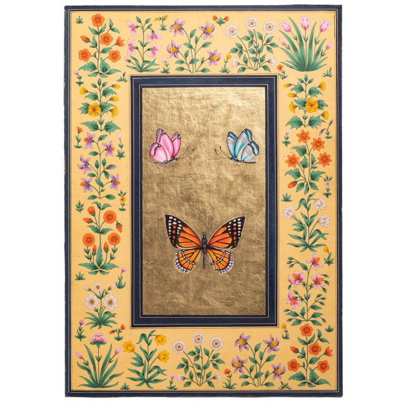 May include: A hand-painted artwork featuring a gold background with a black frame. The artwork depicts three butterflies, one orange and black, one pink, and one blue, surrounded by a border of yellow, orange, and white flowers.