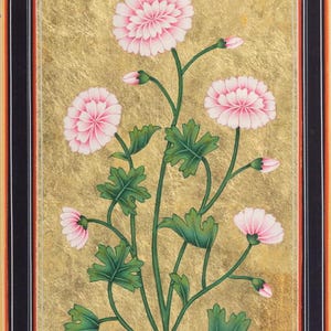 May include: A traditional Indian painting of pink flowers with green leaves on a gold background. The painting is framed in black with a red and white border.