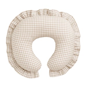 May include: A beige and white gingham nursing pillow with a ruffled edge. The pillow has a crescent shape with a hole in the center, designed for comfortable support during breastfeeding.