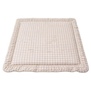 May include: A rectangular mat featuring a beige and white gingham pattern, framed by a ruffled edge. The mat has a quilted design, suggesting a soft texture. The neutral colour scheme makes it suitable for various interior styles.