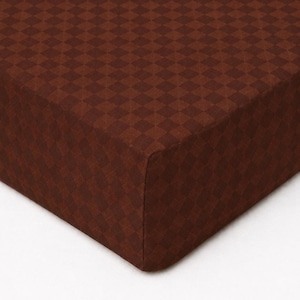 May include: A fitted sheet featuring a dark brown color palette with a subtle, repeating checkered pattern. The fabric displays a consistent geometric diamond grid design across the entire surface, creating a textured appearance in deep brown tones.