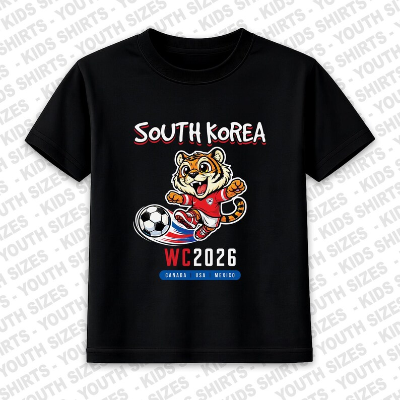 May include: Black t-shirt featuring a cartoon tiger kicking a soccer ball. The shirt has the text "SOUTH KOREA" above the tiger and "WC2026" below, with "CANADA USA MEXICO" underneath.