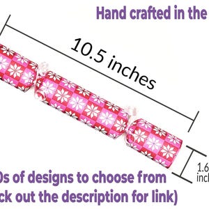 May include: A decorative cracker with a pink and white floral pattern. It measures 10.5 inches long and 1.6 inches wide. The text "Hand crafted in the USA!" and "100s of designs to choose from (check out the description for link)" are also visible.