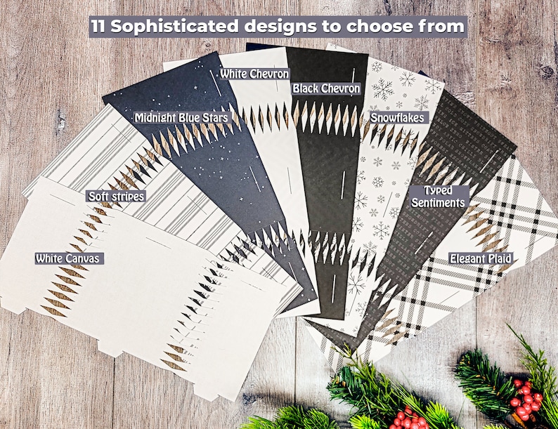 May include: An assortment of 11 sophisticated designs, including "White Canvas", "Soft Stripes", "Midnight Blue Stars", "White Chevron", "Black Chevron", "Snowflakes", "Typed Sentiments", and "Elegant Plaid". The designs are displayed on a wooden surface.