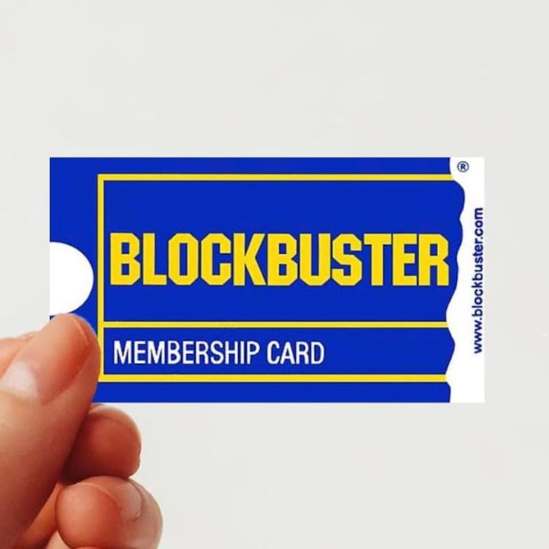 May include: A blue and yellow membership card for Blockbuster Video. The card has the text "Blockbuster" in yellow letters and "Membership Card" in white letters.