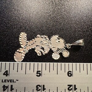 May include: A silver-toned metal pendant shaped like a cartoon mouse character with a textured, diamond-cut finish. The pendant is positioned above a metal ruler, showing a width of approximately 4.5 cm from the left edge to the bail.