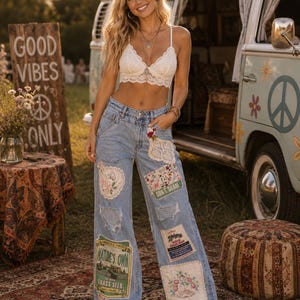 May include: A white lace bralette paired with light-wash denim wide-leg jeans featuring distressed patches, floral embroidery, and vintage-style seed packet labels including text reading Nature's Own Grass Seed and Sun & Share.