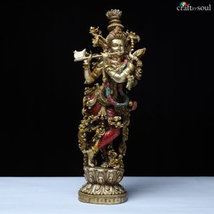 May include: A detailed statue of a deity playing a flute. The figure is adorned with ornate gold and red clothing, jewelry, and a crown. The statue is on a decorative base, with the text "craft by soul" in the upper right corner.