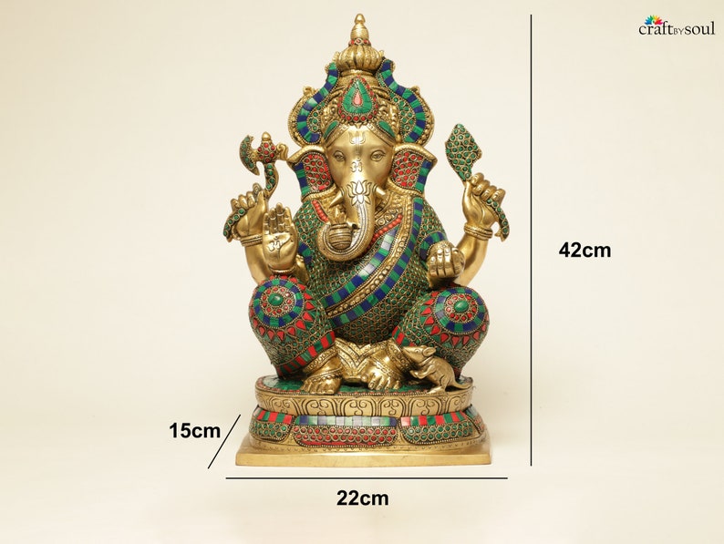 May include: A gold-colored Ganesh statue, 42cm tall, adorned with colorful mosaic-style detailing. The statue features intricate designs with blue, green, and red accents. The base is 22cm wide and 15cm deep. The statue is a representation of the Hindu deity.