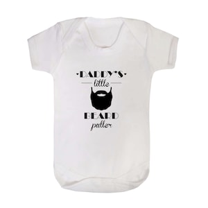 May include: White baby onesie with black text that reads "Daddy's little beard puller" with a black beard graphic.
