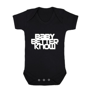May include: Black baby grow with white text that reads "Baby Better Know" in a bold, blocky font.