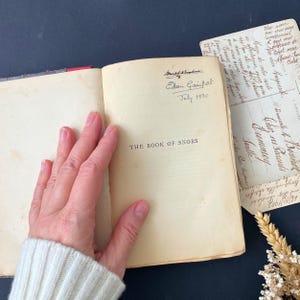 May include: An open book titled "The Book of Snobs" with a handwritten inscription on the inside cover. The inscription reads "Eelam Gaimport. July 1930".