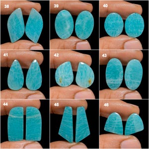 May include: Set of 10 pairs of teal blue amazonite cabochons, each pair is numbered 38-46. The cabochons are smooth and polished, with a variety of shapes and sizes.
