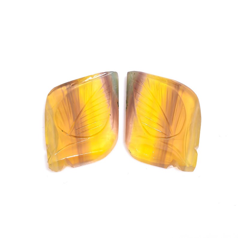 May include: A pair of carved gemstone earrings with a leaf design. The earrings are a mix of yellow, green, and purple.