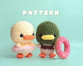 May include: Two crocheted amigurumi toys, a yellow duck and a green duck, both wearing pink and white donut-shaped accessories. The word "PATTERN" is written in white letters on a light blue background.