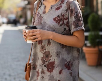 May include: A grey short-sleeved dress featuring a dark red and brown floral print, a notched V-neckline, and cuffed sleeves. The garment has a relaxed, straight-cut silhouette that falls above the knee, crafted from a soft, heathered fabric.