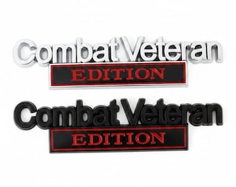 May include: Two rectangular emblems featuring the text Combat Veteran in raised lettering above a smaller rectangular bar with the word EDITION in red. One emblem has a polished silver finish, while the other has a matte black finish.