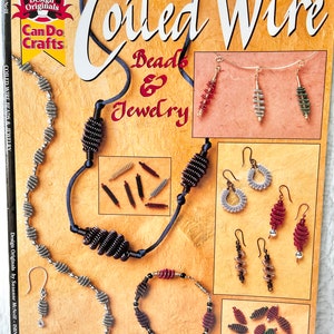 May include: A book titled "Coiled Wire Beads & Jewelry" with a cover featuring various coiled wire jewelry pieces in silver, gold, and red. The book is part of the "Design Originals Can Do Crafts" series.