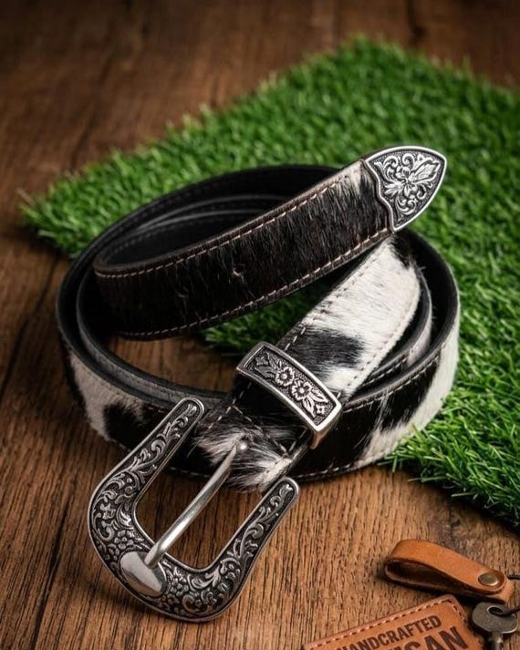 A genuine hair-on cowhide belt with wild texture you can actually see and feel — the $7,500 price tag screams bespoke heirloom commission piece.