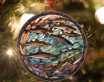 May include: A round stained glass ornament featuring a school of fish swimming in a blue and green ocean. The fish are depicted in shades of brown, green, and blue.