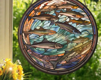 May include: A stained glass window depicting a school of fish swimming in a circular pattern. The fish are a variety of shades of brown, orange, and yellow, and the water is a deep blue with hints of green and purple. The window is framed in a dark brown metal.