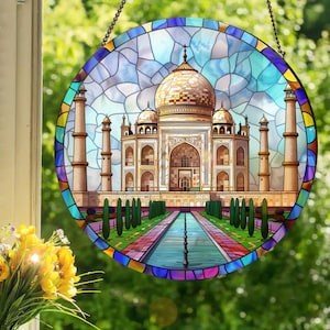 May include: A stained glass window hanging with a colorful depiction of the Taj Mahal, a white marble mausoleum with intricate details, surrounded by a green garden and a reflecting pool.