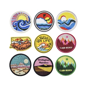 May include: Set of nine embroidered iron-on patches with various designs, including mountains, waves, sunsets, and text. The patches are colourful and feature a variety of styles.