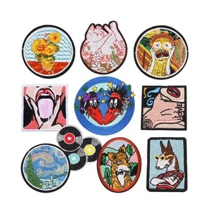 May include: Set of 10 embroidered iron-on patches featuring various designs, including a sunflower, a heart, a screaming face, a tongue, two birds, a record, a fox, and a dog.