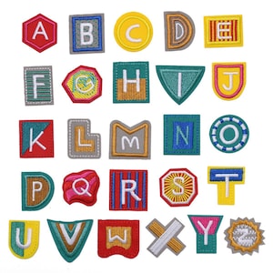 May include: A set of 26 colourful embroidered iron-on patches featuring the alphabet letters A through Z. Each patch has a unique design and colour scheme.