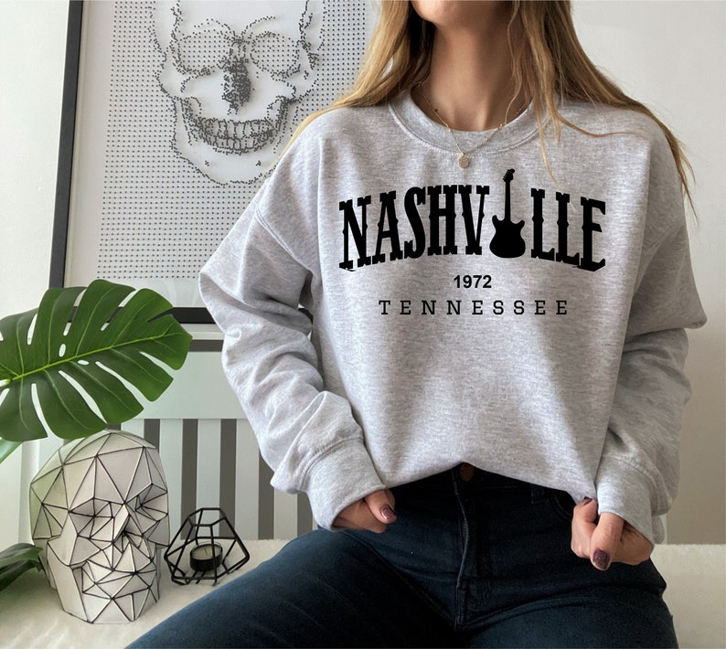 May include: Gray sweatshirt with black text that reads "NASHVILLE 1972 TENNESSEE" with a guitar graphic.