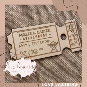 May include: A wooden gift tag shaped like a ticket with the text "MILLER & CARTER - STEAKHOUSE - Merry Christmas From Morg. Dan, Con & Izzie" and the number "&pound;50.00" printed on it.