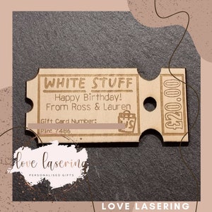 May include: A wooden gift card with the text "WHITE STUFF" and "Happy Birthday! From Ross & Lauren". The card has a gift card number and pin number, and a price of $20.00.