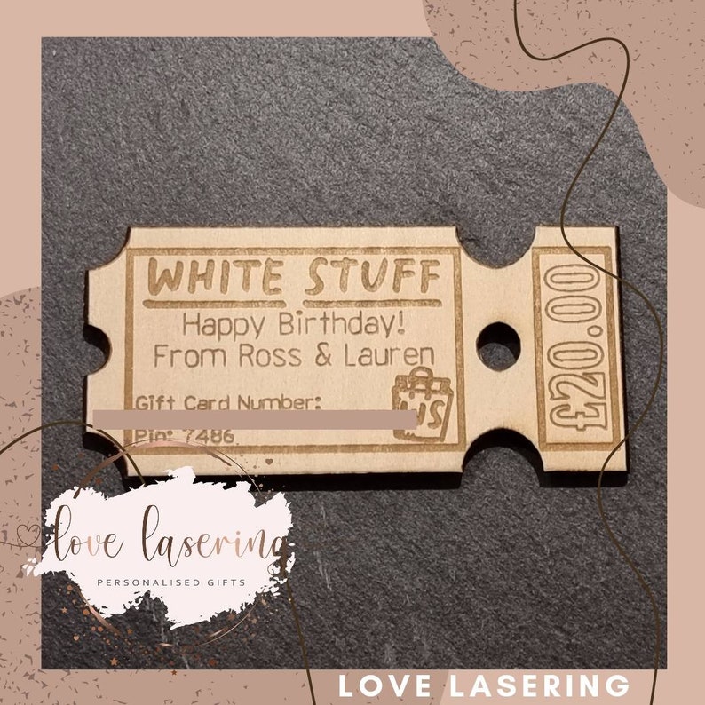 May include: A wooden gift card with the text "WHITE STUFF" and "Happy Birthday! From Ross & Lauren". The card has a gift card number and pin number, and a price of $20.00.