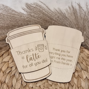 May include: A wooden coffee cup sleeve with the text "Thanks a latte for all you do!" and a small heart. The sleeve is attached to a separate wooden coffee cup cutout with the text "Thank you for everything you have taught me this year, Love From Darcie x".